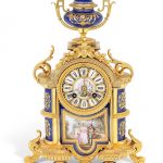 A late 19th century French, gilt bronze and Serves style porcelain inset mantle clock