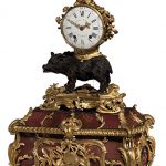 A LOUIS XV PATINATED BRONZE, ORMOLU AND RED HORN STRIKING MANTEL CLOCK ON MUSICAL PLINTH: 'PENDULE AU SANGLIER'