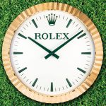 INDUCTA FOR ROLEX. A LARGE AND UNUSUAL GILT METAL QUARTZ WALL CLOCK